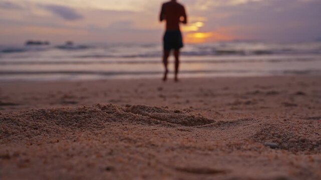 Close Up of a Man Picking Up a Snorkeling Mask From Sandy Beach at Sunset, Evening Seaside Leisure and Summer Travel Before a Swim