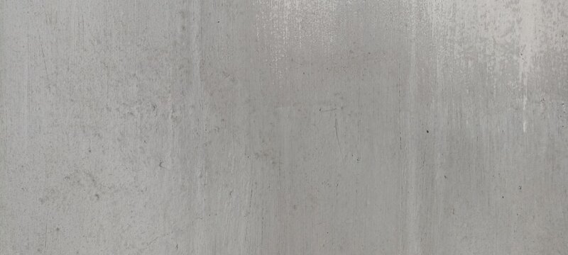 Concrete texture background with smooth grey surface and faint vertical streaks, suitable for modern architectural layouts, industrial posters, and minimalist backdrops