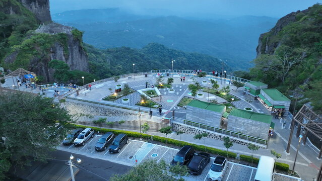 Aerial view of Centro Recreativo Cultural Puerta del Diablo with its observation deck and parking area between rocky cliffs in Planes de Renderos, San Salvador Department, El Salvador.