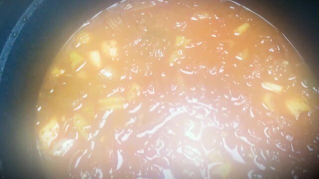 Steam fogs the lens above homemade kimchi jjigae in a hot pot.