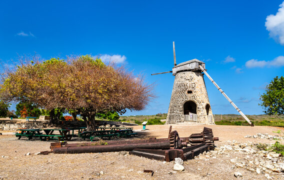 A restored stone windmill and old sugar mill machinery at Betty's Hope Historic Sugar Plantation on the island of Antigua.