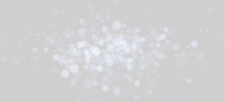 Clusters of soft blue bokeh lights float against a dark background. The circular shapes vary in size and intensity, creating a glowing effect. This image is useful for festive, magical, or.