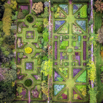 Aerial view of Ardgillan Castle and Gardens featuring geometric flower beds, manicured hedges, and lush lawns in a historic walled garden in Lancaster Cottages, County Dublin, Ireland.
