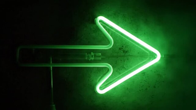 Glowing green neon arrow sign pointing right with mysterious smoke effect