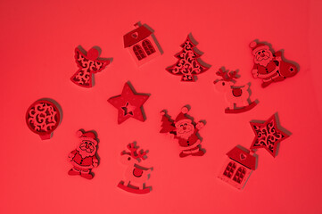 Fototapeta premium Christmas ornaments scattered on red background creating holiday pattern