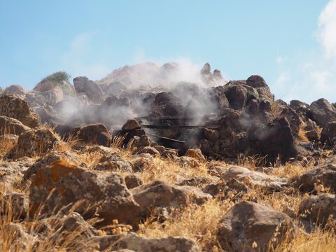 Steam rising from volcanic rocks at Favara Grande fumarole field in Pantelleria island