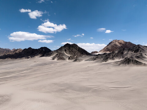 barren gobi desert landscape with black rock formations at hei du shan