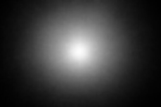 Monochrome radial vignette backdrop with central luminous glow, smooth grayscale gradient, softened edges, subtle grain texture, minimalist light burst for editorial design