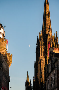 Gothic spire and moon above Edinburgh Old Town skyline