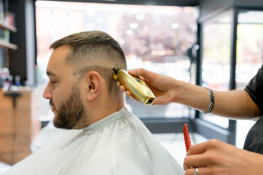 Barber use clipper for men's fade haircut at barbershop