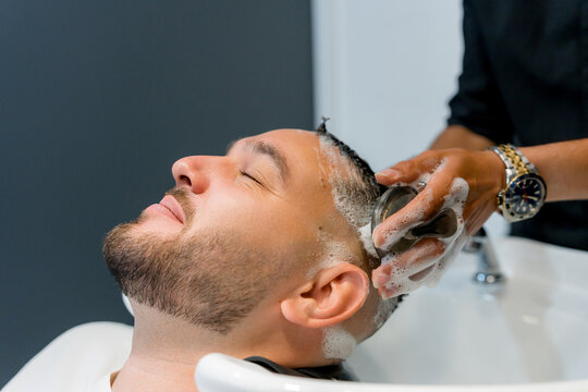 Man receive relaxing hair wash at barbershop salon