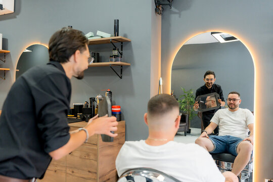 Barber show male client fresh haircut in modern barbershop