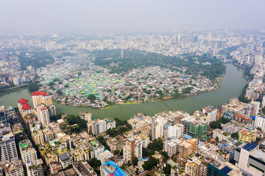 Aerial view of the Gulshan 2 area featuring a dense mix of modern high-rise buildings and informal settlements along the banks of the Gulshan Lake Dhaka, Dhaka Division, Bangladesh.