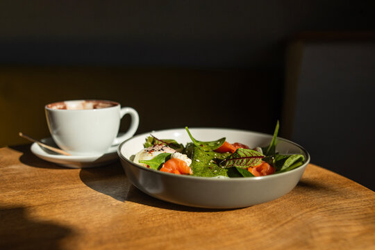 Green spinach crepes with salmon and poached egg