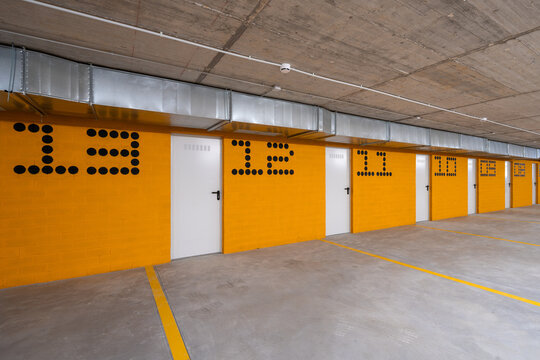 Modern hillside residential parking garage with numbered spaces