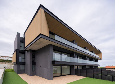 Modern hillside residential house with glass balcony facade