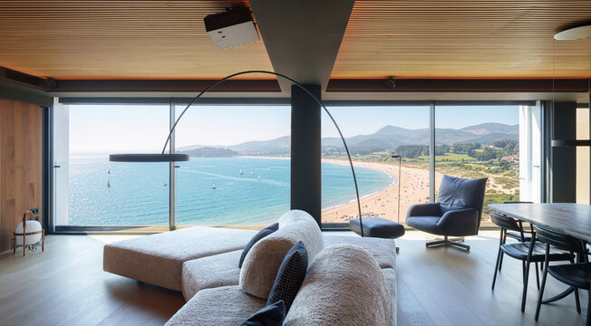 Modern wooden coastal living room with panoramic ocean view