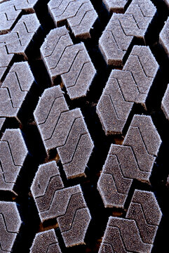Frost-covered tire tread pattern macro texture background