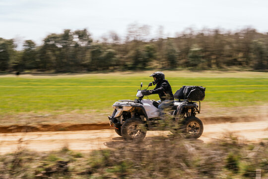 Quad rider enjoy off-road adventure on dirt trail