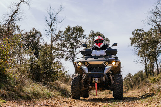 Quad rider enjoy off-road adventure on forest trail