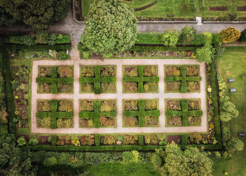 Aerial view of the geometric garden beds at Ardgillan Castle and Gardens with manicured hedges and gravel paths in Lancaster Cottages, County Dublin, Ireland.