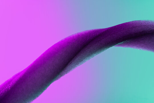 Abstract purple fabric curve on turquoise gradient background