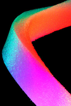 Colorful glowing curved foam texture on black background