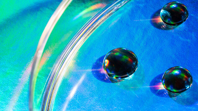 Macro view of water droplets in a colorful petri dish