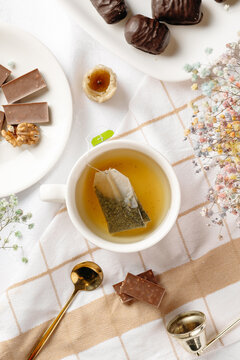 Herbal tea with chocolate, walnut and dried fruit sweets