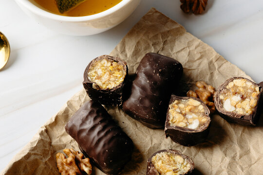 Chocolate coated biscuit bites with tea in close-up