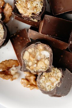Chocolate coated walnut candy pieces in macro close-up