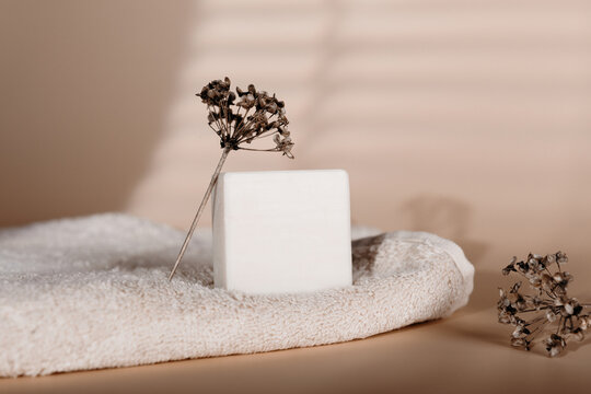 Natural soap bar on towel with dried flower