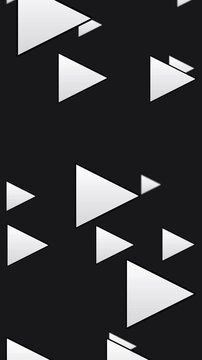 Seamless loop. White play button triangles march across black screen in vertical motion graphic. Monochrome media symbols drift in flowing pattern for streaming and entertainment themes.