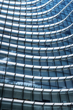 Curved geometric glass facade of a contemporary office building