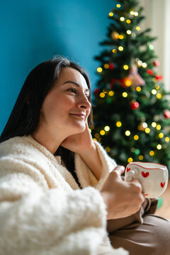 Woman enjoy Christmas at home with festive hot drink