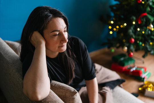 Lonely woman reflect at home during Christmas holiday