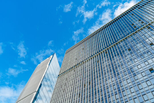 Modern office tower facade against blue sky in city