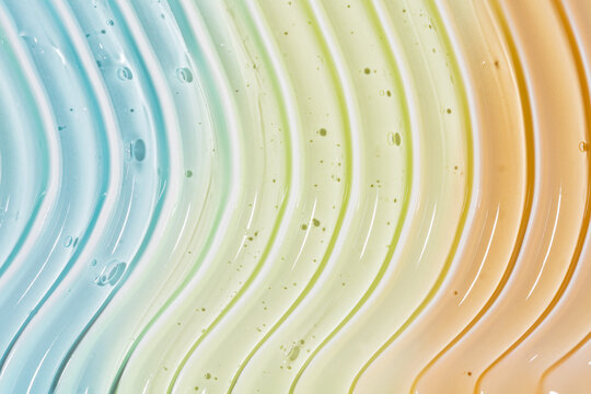 Pastel cosmetic gel smear texture with translucent wave pattern