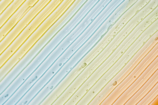 Pastel cosmetic gel smear texture with diagonal streaks