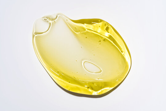Yellow cosmetic gel smear with translucent glossy texture