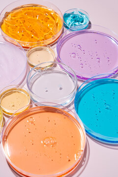 Colorful cosmetic gel samples in Petri dishes