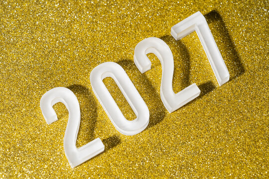 White 2027 numbers on glittering gold new year background