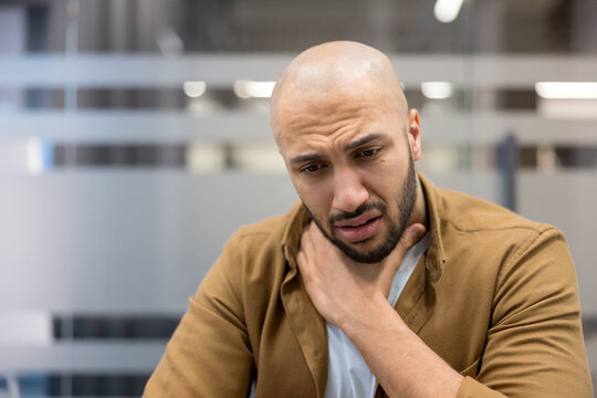 Sore throat and health issues, man suffering from neck pain or illness in office, Physical discomfort and medical symptoms
