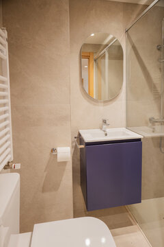 Modern apartment bathroom with vanity mirror and shower