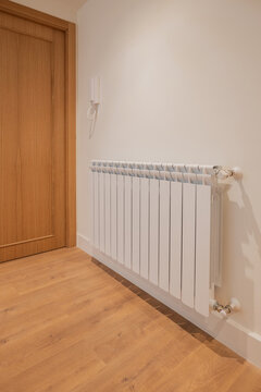 Modern apartment hallway with wall-mounted radiator heating