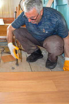 Craftsman install hardwood flooring during home renovation