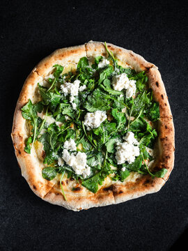 Pizza with smoked salmon, ricotta and arugula toppings