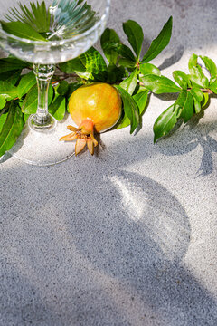 Pomegranate and glassware on an autumnal table set