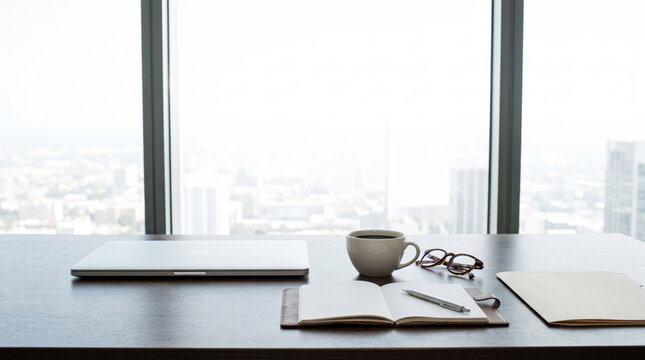 Executive desk still life with laptop, notebook and coffee