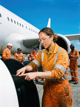 Engineer inspecting fan blades on an aircraft engine